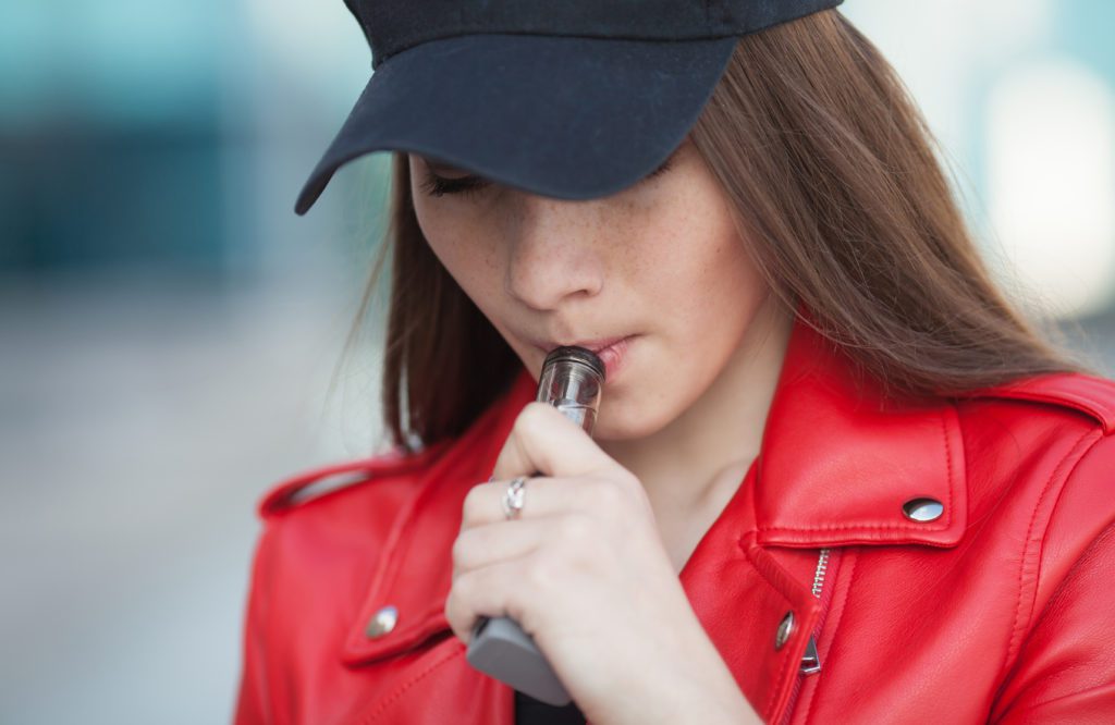 A girl enjoying cbd vape