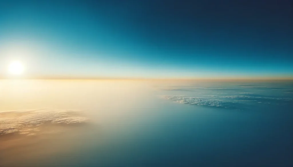 Expansive clear blue sky with not a single cloud in sight. The sun is just below the horizon, casting a soft golden hue on the edges. This serene and unobstructed view symbolizes mental clarity and peace of mind.